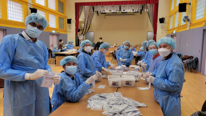 Packing of rapid test kits by volunteers recruited by Tai Po District Office