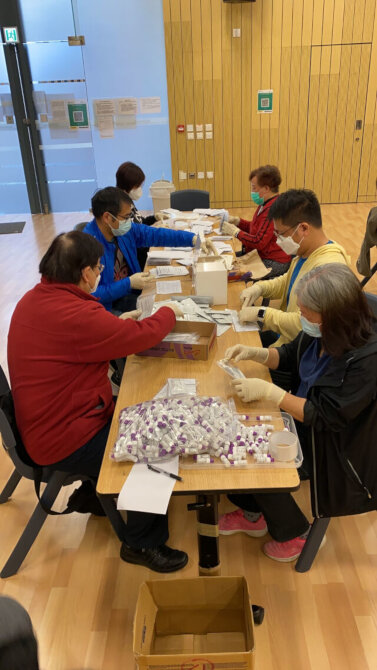 The Tsuen Wan District Office arranges staff to pack COVID-19 rapid test kits1