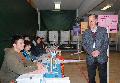 The Secretary for Home Affairs, Mr Tsang Tak-sing (right), visits the polling station at Buddhist Chan Wing Kan Memorial School today (January 23).