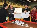 The Secretary for Home Affairs, Mr Tsang Tak-sing; the Returning Officer, Mr Yeung Tak-keung; and the Director of Home Affairs, Mrs Pamela Tan, empty a ballot box at the counting station at Fung Kam Street Sports Centre.